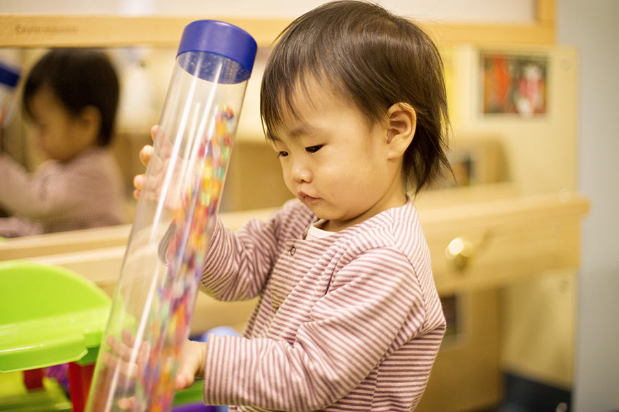 Child playing with sensory tube