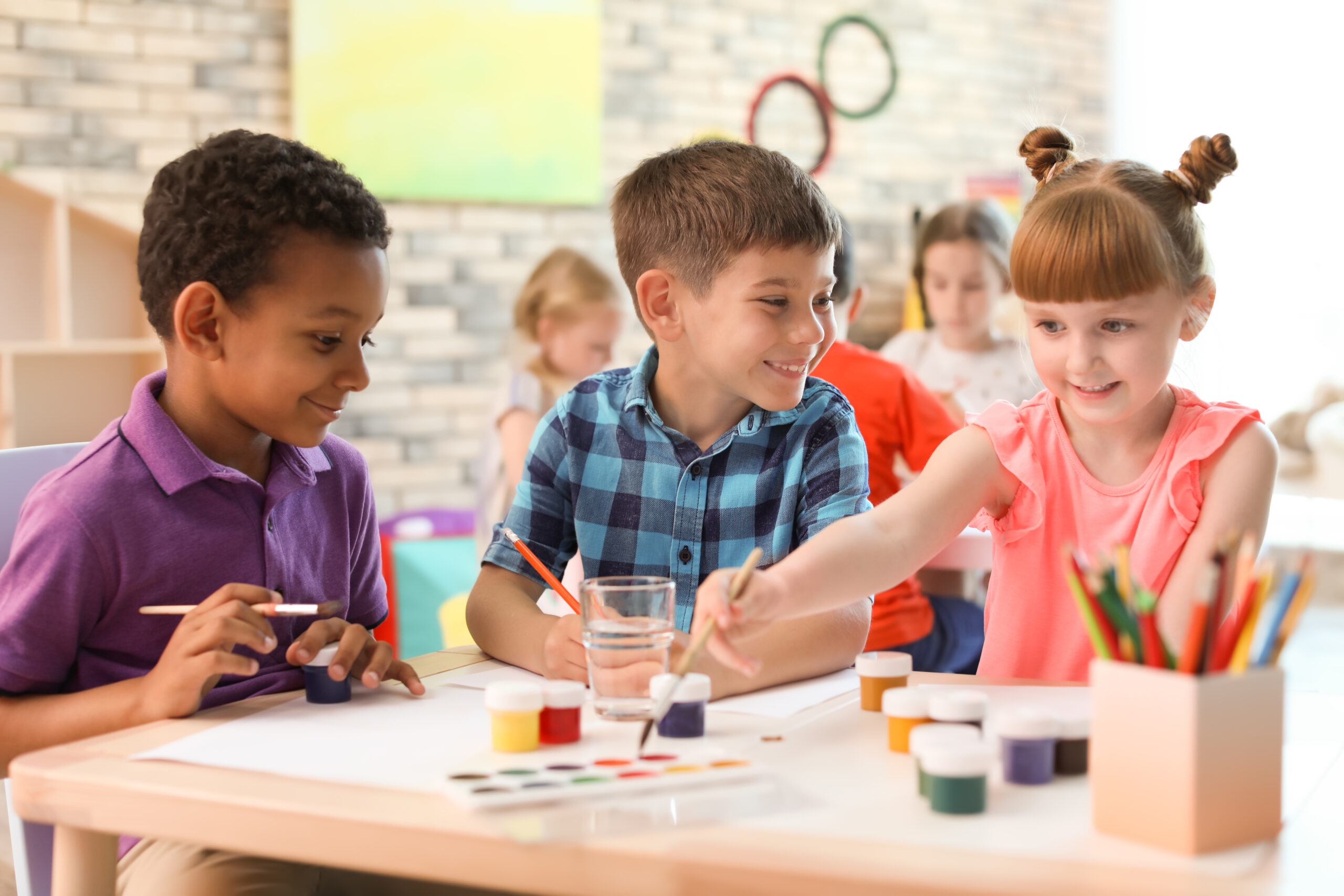 View of a child care classroom arranged neatly with shelves and tables.