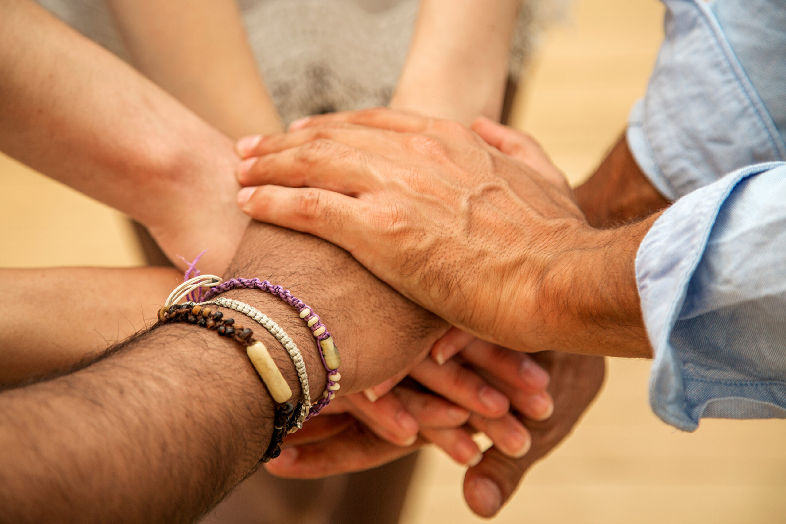 Hands stacked together in a group high five.