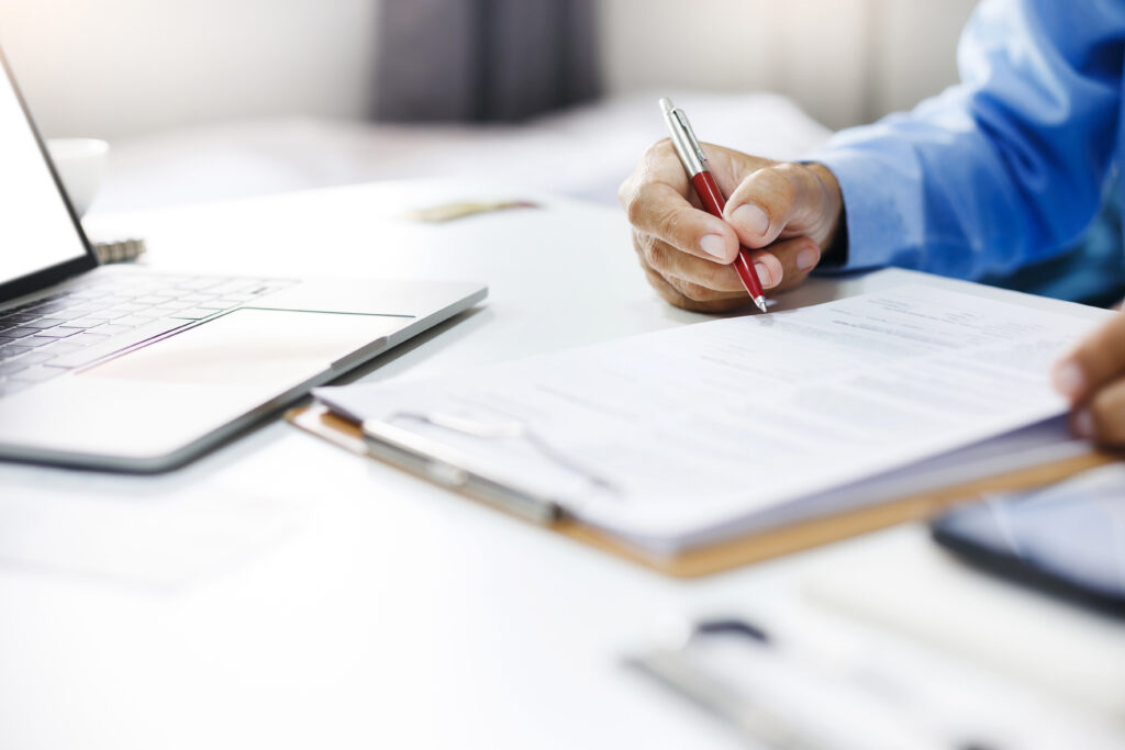 A person writing on a clipboard