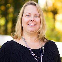 Headshot of Michelle Johnson outside in front of trees.