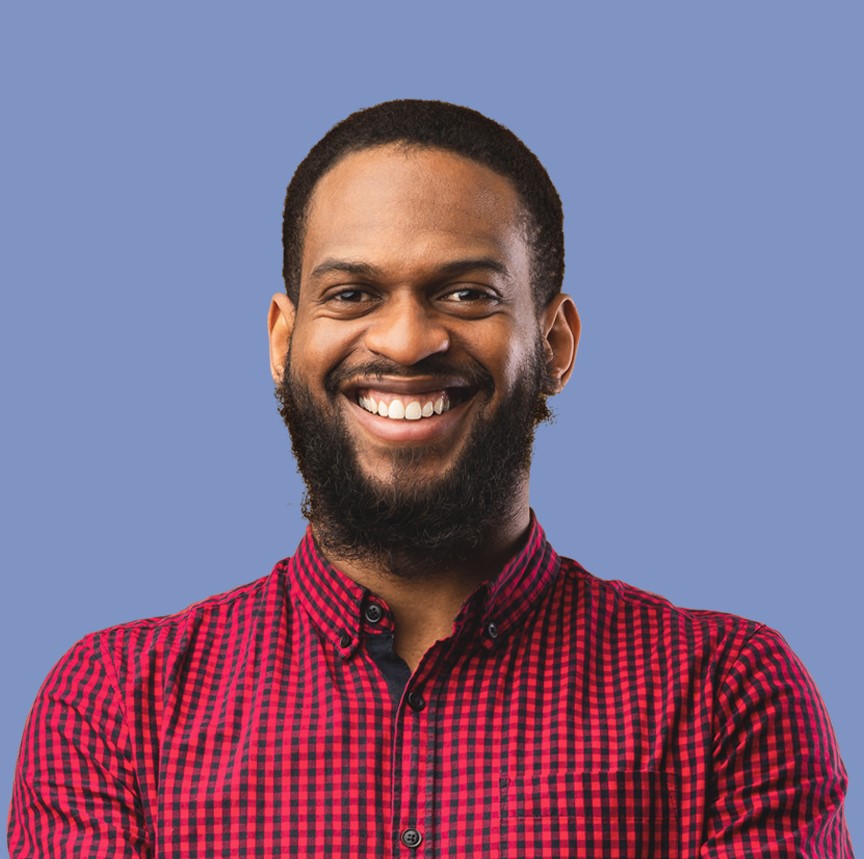 Young man with a dark beard and short hair wearing a red shirt.